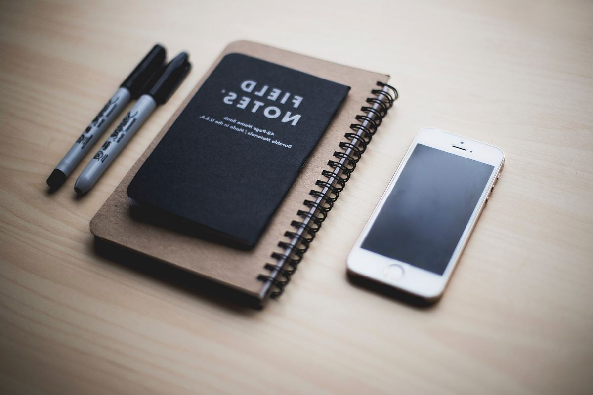 silver iPhone 5s near Field Notes book